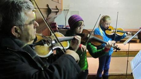 Musiklehrer Karl Wilhelm Agatsy und die Violinschülerinnen Maria Kern und Nina Peter.  Fotos: Katharina Wachinger