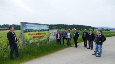 Kreisobmann Wolfgang Scholz (links), Geschäftsführer Thomas Müller (Vierter von rechts) und Ortsobmänner und Ortsbäuerinnen protestieren gegen die Umnutzung wertvoller Ackerflächen für den Straßenbau bei Weilheim.