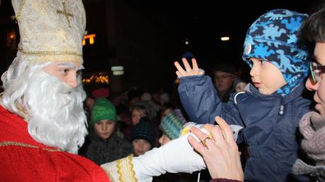 Der heilige Nikolaus und Knecht Ruprecht überraschen die Kinder auf dem Fischacher Weihnachtsmarkt. 