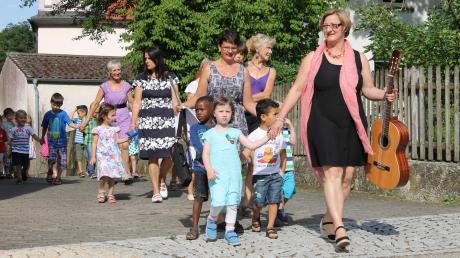 Die Kinder marschierten mit Betreuerinnen von der St.-Vitus-Kirche zum Pfarrsaal. An der Spitze Kindergartenleiterin Heike Brummer (mit Gitarre). 