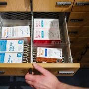 Eine Apothekerin öffnet ein Schubfach mit Antibiotika-Säften für Kinder. Sie sind schon jetzt, vor der Erkältungs- und Grippesaison, kaum zu bekommen.