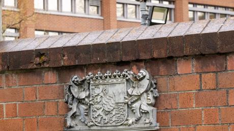 Das bayerische Wappen hängt vor dem Gebäude des bayerischen Landesamt für Verfassungsschutz.