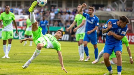 Wolfsburgs Joakim Maehle (l) netzt den Ball mittels Fallrückzieher ein.