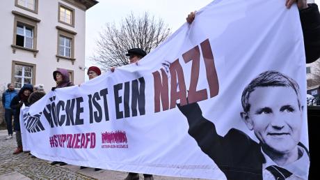 "Björn Höcke ist ein Nazi" steht auf dem Transparent mit dem Bild von Björn Höcke, Thüringer AfD-Chef, das Teilnehmer einer Demonstration vor dem Thüringer Landtag in den Händen halten.