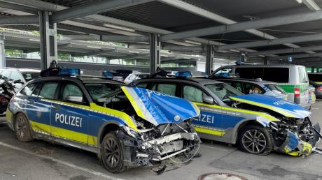 Zwei komplett zerstörte Polizeiautos warten in Neu-Ulm auf die Weiterverarbeitung. 