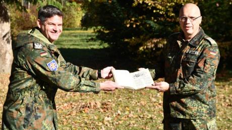 Brigadegeneral Rainer Simon (rechts) übergab das Buch jüngst an den Standortältesten Matthias Raith.
