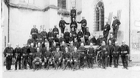 So sah die Rainer Feuerwehrmannschaft im Jahr 1911 aus. Sie hat sich hier für den Fotografen vor der Stadtpfarrkirche aufgestellt.
