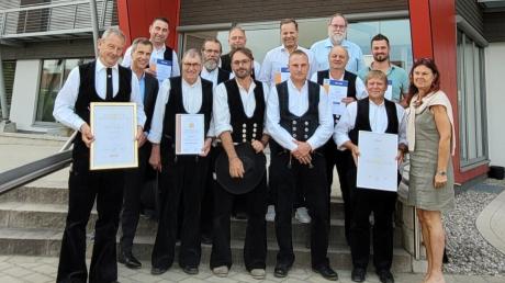 Die Mitglieder der Zimmerer-Innung Günzburg-Krumbach mit ihren Zertifikaten und Urkunden vor den Holzwerken Aumann in Ziemetshausen, wo die Innungsversammlung stattfand.