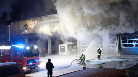 Einsatzkräfte der Feuerwehr löschen den Brand auf dem Busdepot am Günzburger Bahnhof.