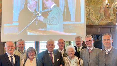 Der Jubilar Reinhard Pachner mit seiner Ehefrau Maria und einigen der zahlreichen Festgäste beim Empfang zu seinem 80. Geburtstag im Friedberger Rathaus. Im Hintergrund liefen Bilder aus seinem Leben.