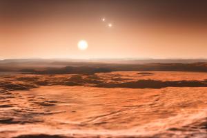 Das Dreifach-Sternsystem Gliese 667 (es ist 22 Lichtjahre entfernt) wird von mindestens zwei Planeten umkreist. Einer davon könnte erdähnlich sein (hier eine künstlerische Darstellung, wonach die fremde Welt eine Art Wüstenplanet sein könnte).
