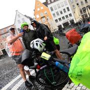 Kalt erwischt vom Dauerregen wurden die ungarischen Radfahrer Radfahrer (von links) Barna Medgyesi, Gabor Agardi und Istvan Fancsalszkiaus auf dem Augsburger Rathausplatz. Sie sind auf der Romantischen Straße Richtung Schweiz unterwegs.
