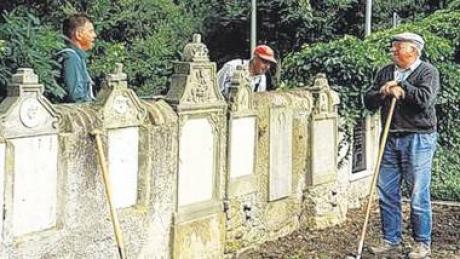 Mitglieder des Freundeskreises Alt Rain e. V. bei der Sanierung der Priestergräber im Friedhof von Rain. 