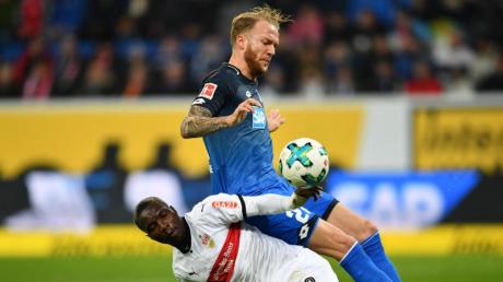 Der Stuttgarter Chadrac Akolo (l) versucht Hoffenheims Kevin Vogt unsanft vom Ball zu trennen.