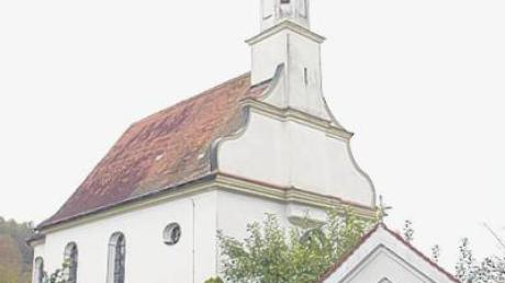 Die Kirche St. Oswald in Glöttweng mit dem Bildstock „Zur schmerzhaften Muttergottes“.  