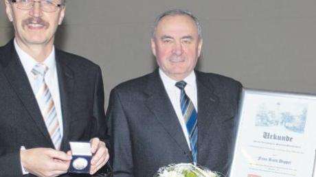 Im Namen seiner Frau Ruth Dippel nahm Helmut Dippel (rechts) beim Kötzer Neujahrsempfang aus der Hand von Bürgermeister Ernst Walter die Silberne Bürgermedaille samt Urkunde und Blumen entgegen. 