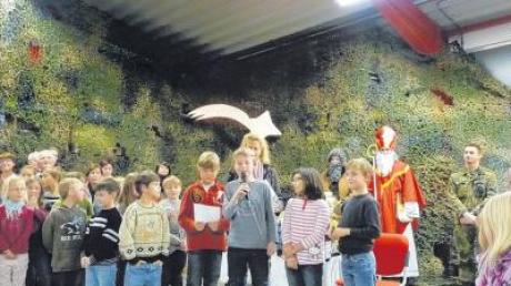 Mit Liedern und Gedichten sorgten die Kellmünzer Kindergartenkinder und Grundschüler (Bild) für vorweihnachtliche Stimmung bei der Waldweihnacht. Ganz rechts: Kompaniechef Hauptmann Christian Grähn. 