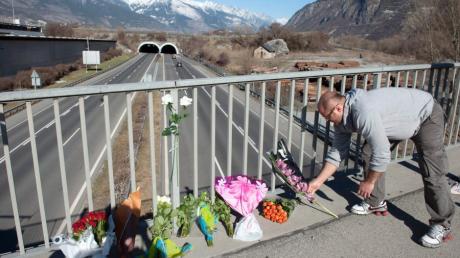 Unweit der Unfallstelle legen Menschen Blumen ab: Bei einem Busunglück im Wallis sind mindestens 28 Menschen gestorben. Es ist der schlimmste Verkehrsunfall, der sich in der Schweiz jemals ereignet hat.