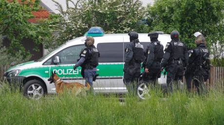 Sondereinsatzkräfte laufen am Dienstag (22.05.2012) nahe dem Sportplatz von Memmingen/Steinheim (Schwaben). Ein Schüler, der in einer Schule einen Schuss abgegeben hatte, hatte sich in der Nähe verschanzt. Archivbild