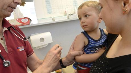 In der Günzburger Kinder- und Jugendarztpraxis gibt Kinderarzt Dr. Karsten Stahnke dem zweieinhalb-jährigen Rafael eine Impfung.
