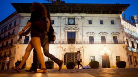 Passanten laufen am Rathaus in Palma de Mallorca vorbei. Die spanische Mittelmeerinsel will die Winterzeit abschaffen.