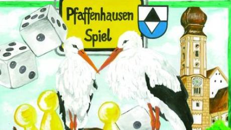 So sieht die Verpackung des Pfaffenhausen-Spiels aus: Zwei Störche umgeben von Spielfiguren, Würfeln und der Kirche des Marktfleckens. Foto: Gemeinde