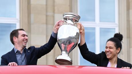 Philipp Lahm, Turnierdirektor der Fußball-Europameisterschaft, hält zusammen mit der früheren Fußball Nationalspielerin Celia Sasic den EM-Pokal hoch.