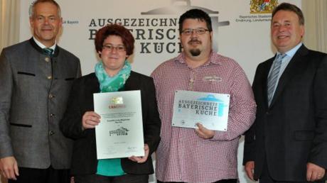 Helmut Brunner (rechts) verlieh an Annette und Robert Neumaier (mittig) zusammen mit Ulrich N. Brandl vom Gaststättenverband (links) die Urkunde.  
