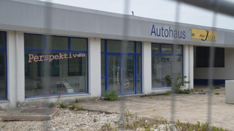 Das leer stehende Autohaus Joas in Oettingen. Auf dem Gelände soll eine Rossmann-Filiale und ein Rewe-Supermarkt kommen, doch ein Anlieger klagt. Daher ist seit 2012 nichts passiert. 