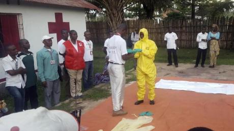 Mitarbeiter vom Roten Kreuz im Kongo ziehen im Vorfeld der Suche nach Infizierten des Ebola-Virus Schutzkleidung an.