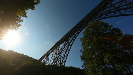 Die Müngstener Eisenbahnbrücke, eine Bogenfachwerkbrücke aus Stahl, führt über ein Tal der Wupper.