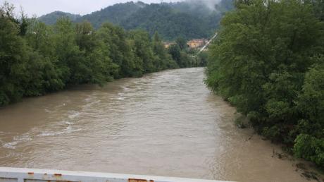 Ein Fluss ist nach heftigen Regenfällen bedrohlich angeschwollen.