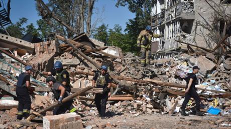 Ukrainische Rettungskräfte arbeiten nach einem russischen Angriff auf Orichiw in den Trümmern eines zerstörten Gebäudes.