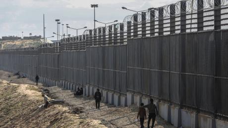 Palästinenser stehen nahe der Grenze zwischen dem Gazastreifen und Ägypten.