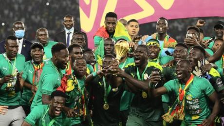 Senegals Spieler feiern mit dem Afrika Cup nach dem Sieg.
